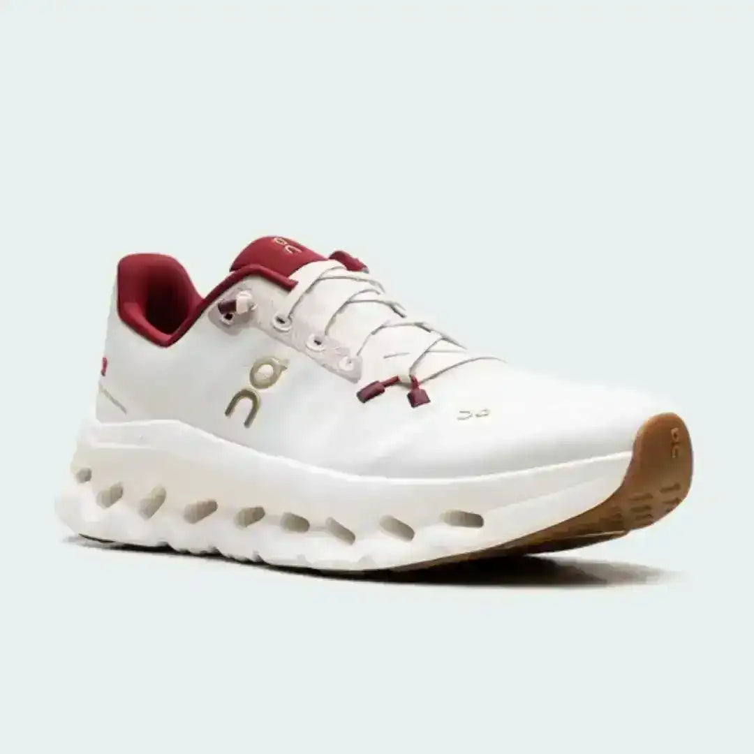 Off-white lace-up sneakers with red collar accents and cutout-style midsoles.