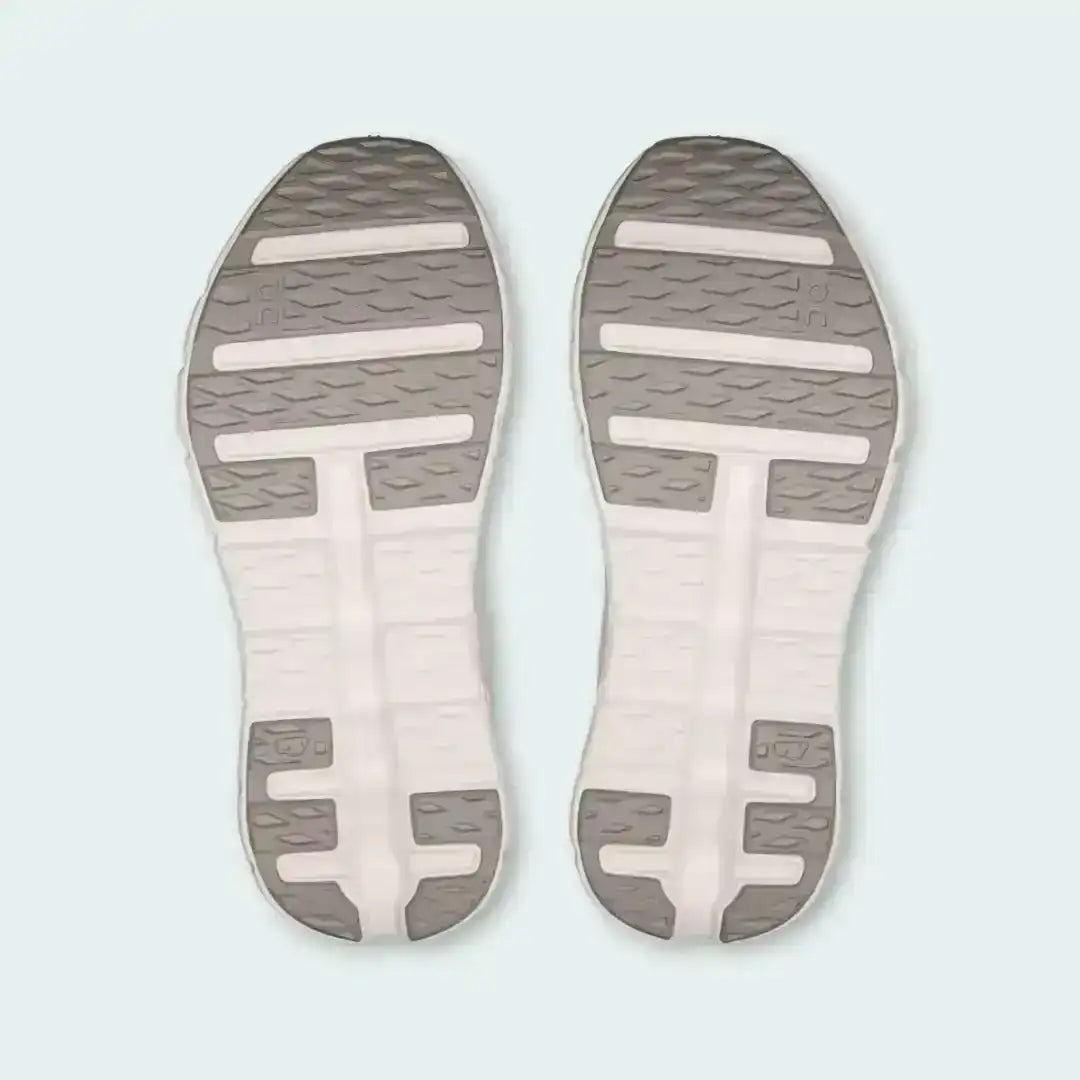 Pale pink sneaker outsoles with contrasting strips, bottom pair view.