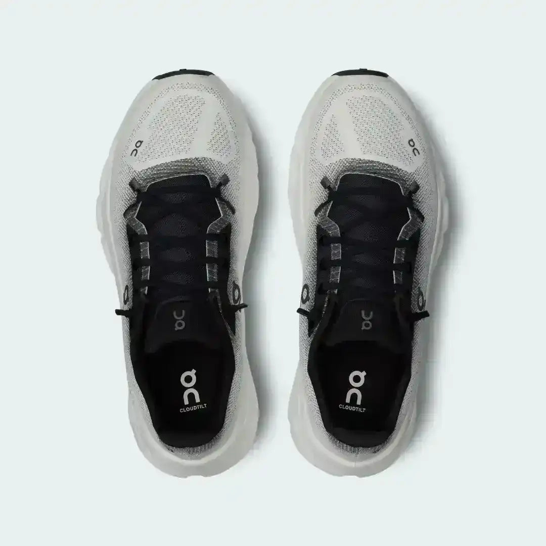 White and black lace-up sneakers with cutout-style midsoles.