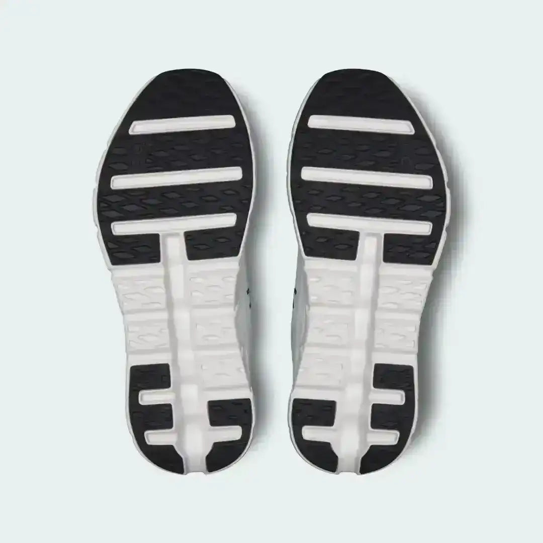 Black and white sneaker outsoles with contrasting strips, bottom pair view.