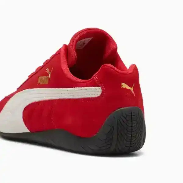 Detail shot of Puma Speedcat heel featuring the iconic rounded driver's sole and gold cat logo