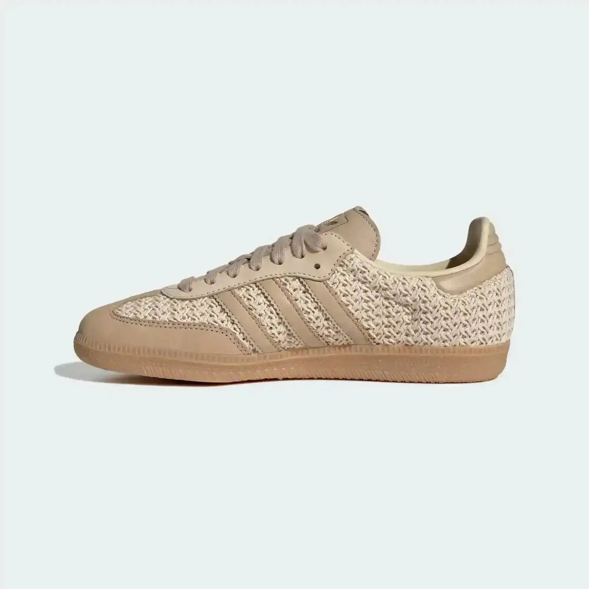 Beige woven-texture low-top sneakers with light stripes and gum soles.