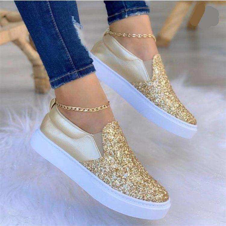Glitter-finish platform slip-on shoes styled with jeans.