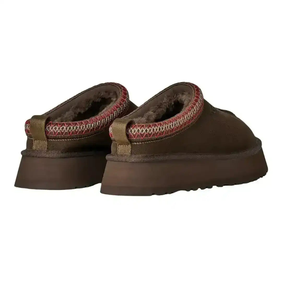 Dark brown UGG Tazz suede mules with contrasting braid stitching, offering a subtle pop of detail to a classic winter shoe silhouette.