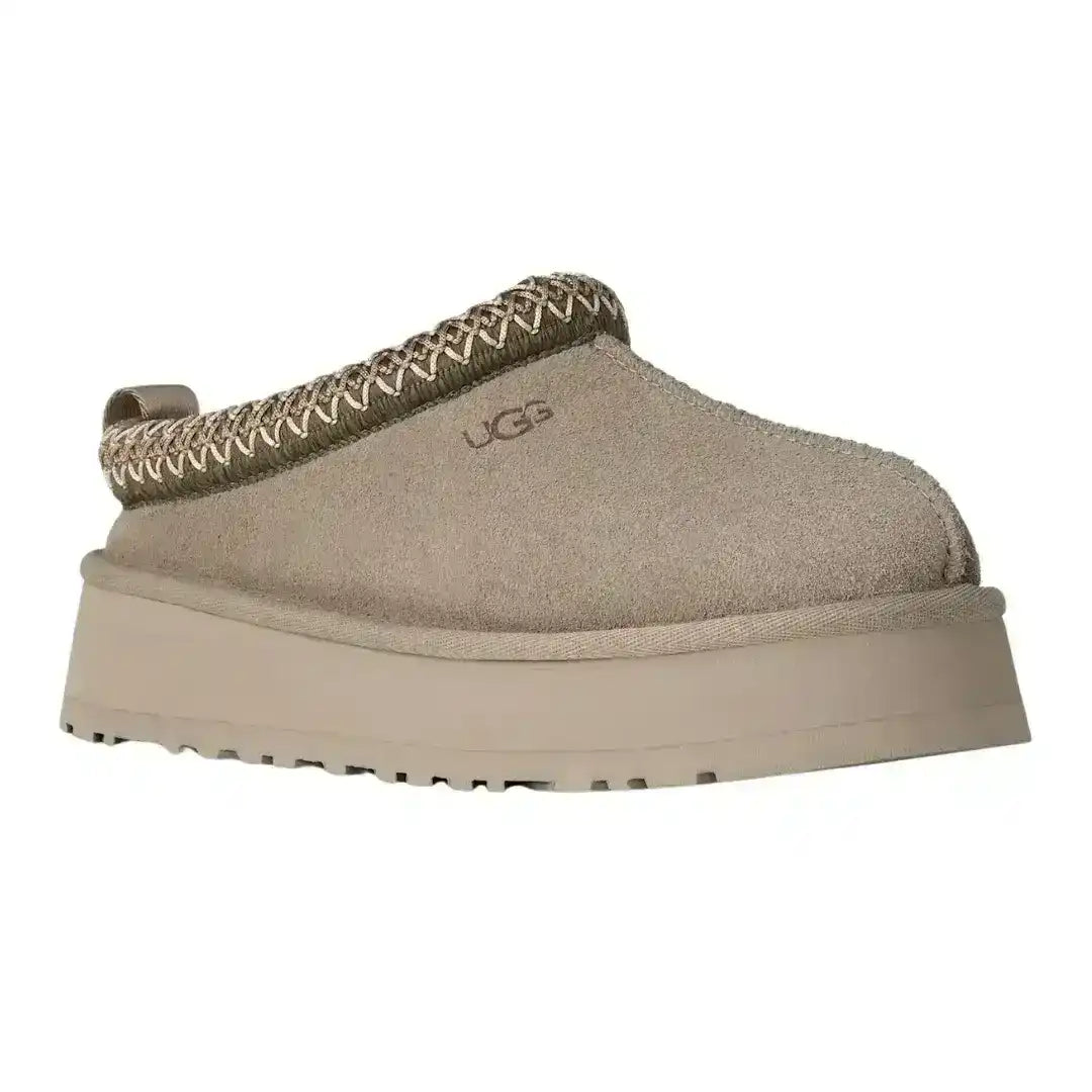 Women's UGG Tazz suede mules in sand color with chunky sole, trending footwear for casual street style and cozy home lounging now.