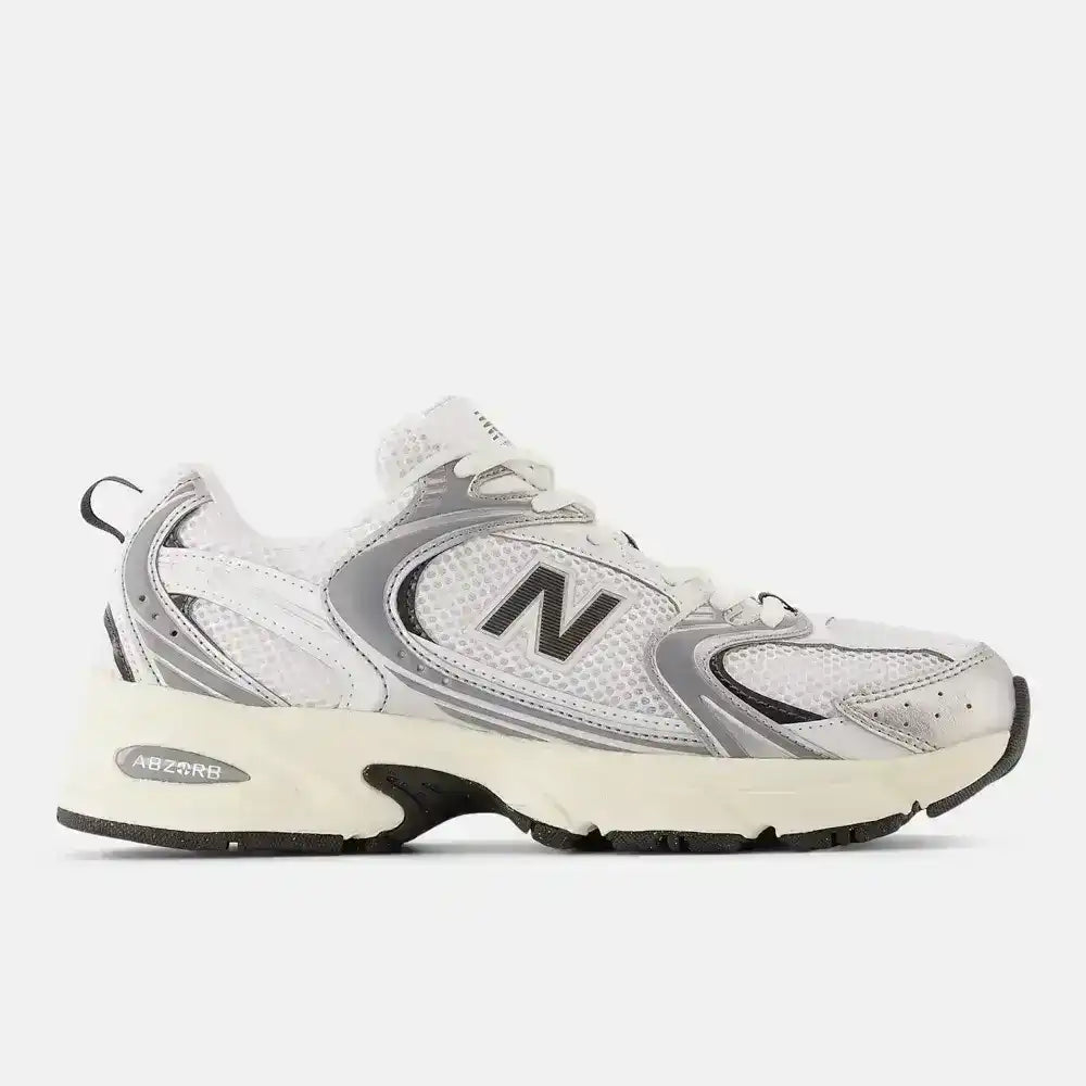 Cream and gray mesh-panel sneakers with dark N-shaped side logos.
