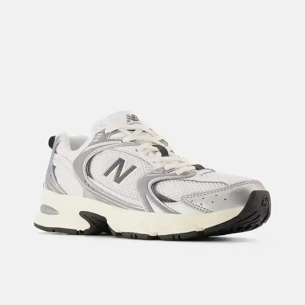 Cream and gray mesh-panel sneakers with dark N-shaped side logos.