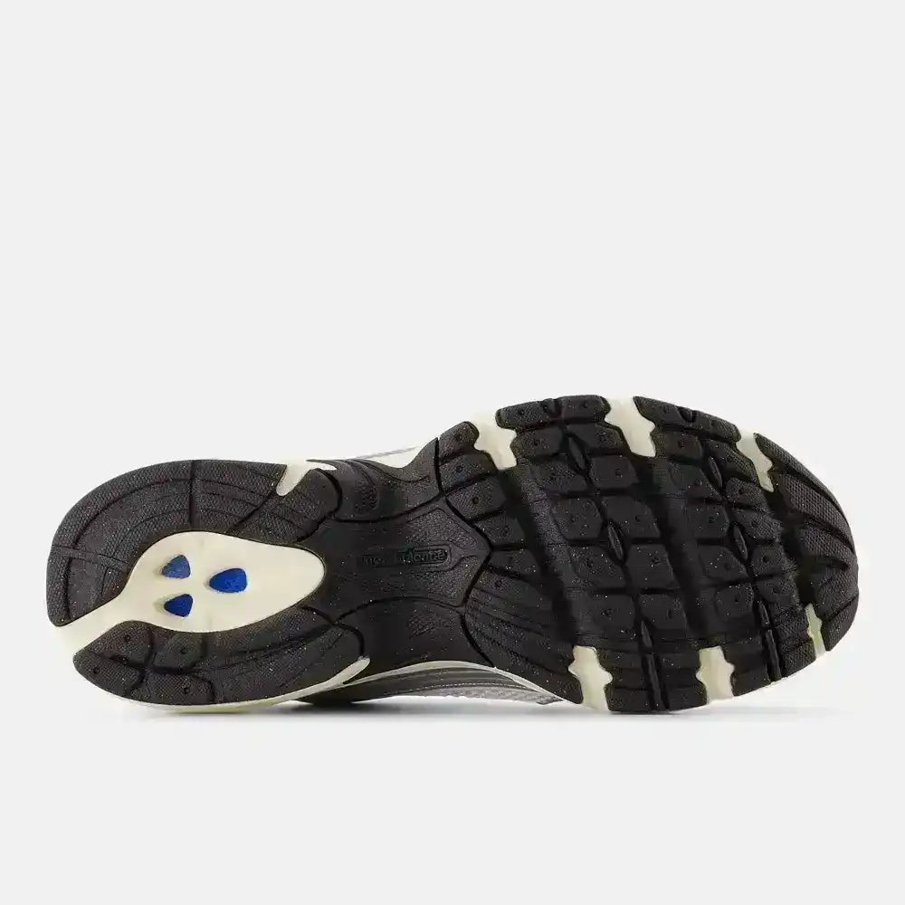 Black sneaker outsole with contrasting white sections, bottom view.