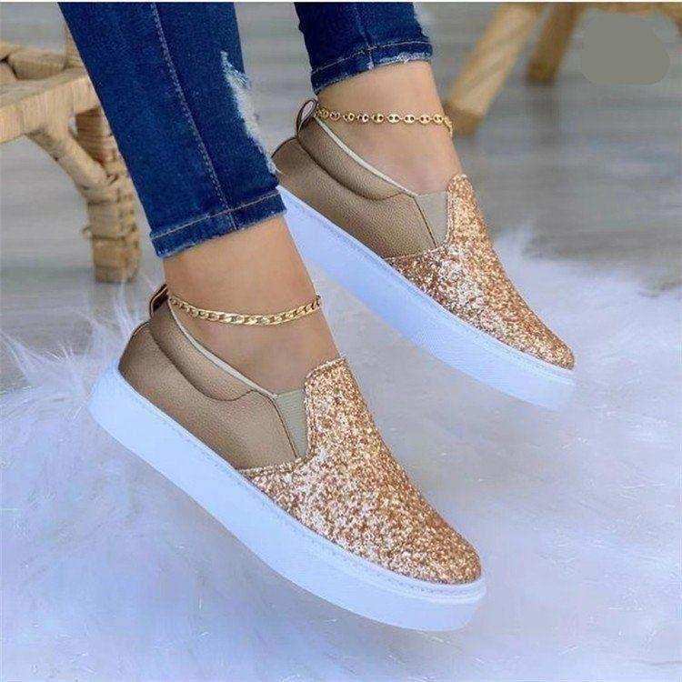 Glitter-finish platform slip-on shoes styled with jeans.