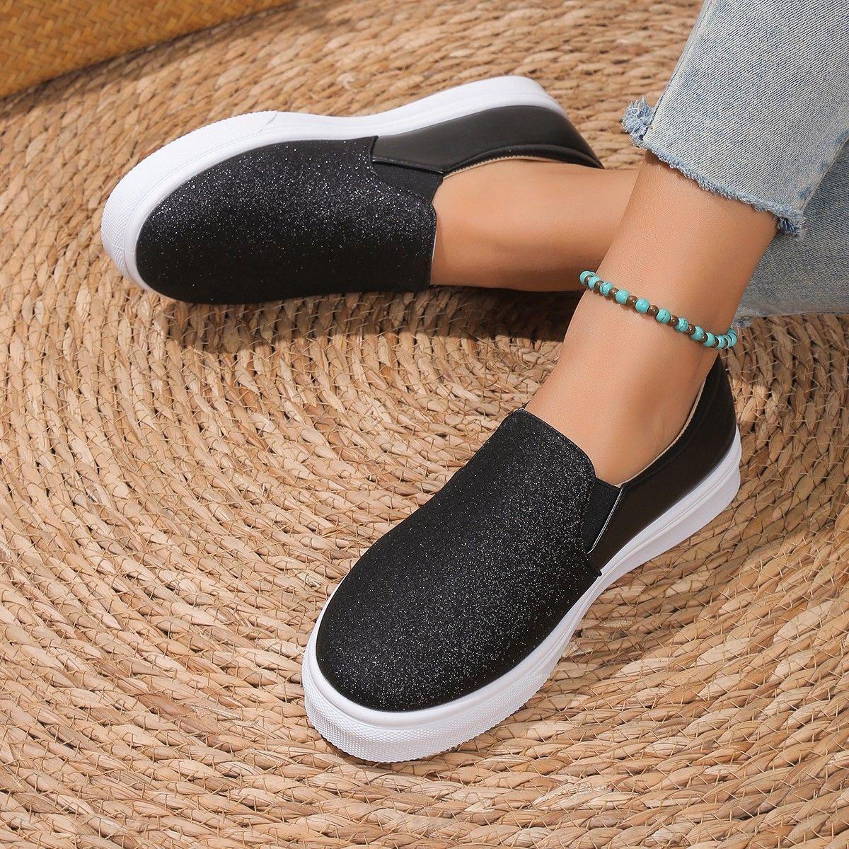 Discreet Shoes Stardust Platform Slip-On in black glitter finish with chunky white platform sole - side profile