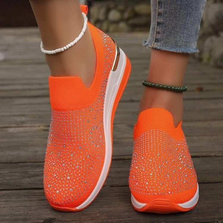 Rhinestone-decorated slip-on sneakers in several colors.