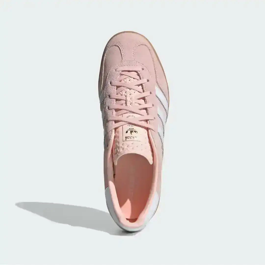 Studio shot of the pink Adidas Gazelle Indoor shoes, highlighting the textured tongue design, clean white lacing system, and the durable semi-transparent gum cupsole.