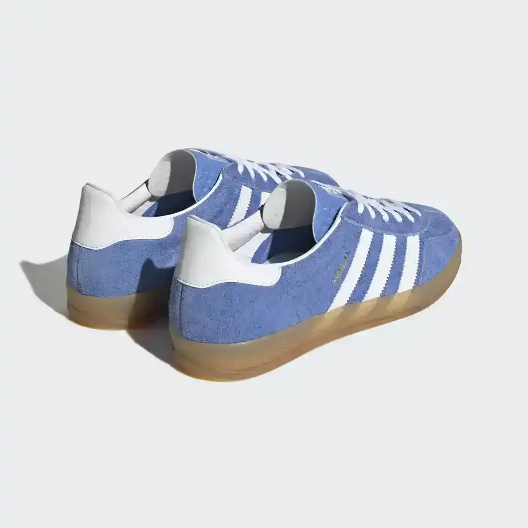 Adidas Gazelle Indoor silhouette in blue suede with white accents, perfect for a retro look with its vintage-inspired translucent gum rubber bottom.