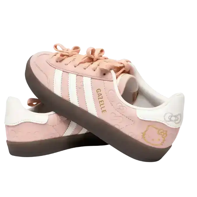 Adidas Gazelle Indoor Hello Kitty sneakers in a soft beige colorway, featuring unique bow-shaped laces, white serrated stripes, and an all-over embossed bow pattern on the leather upper.