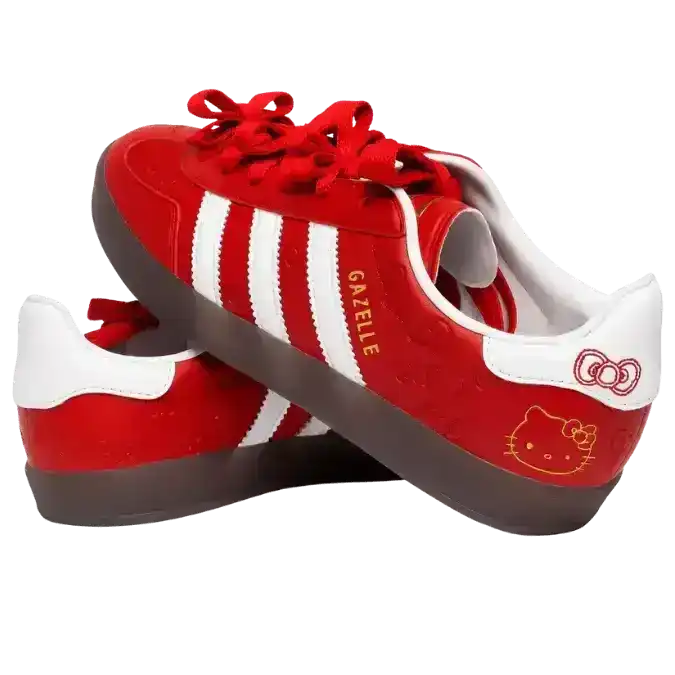 Hello Kitty x Adidas Gazelle shoes in red and white, highlighted by a dark translucent gum sole, gold metallic branding, and a cute Hello Kitty face graphic on the outer heel.
