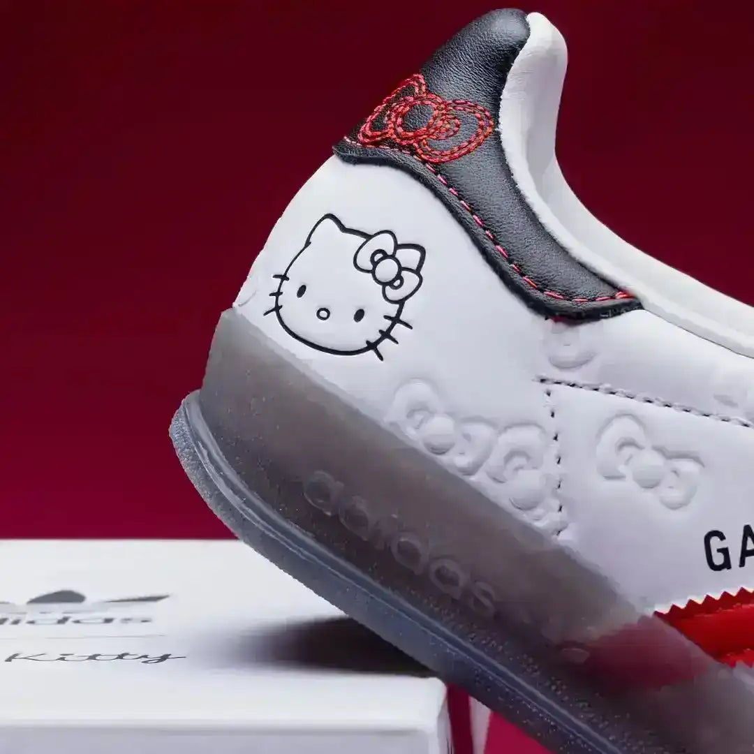 close up of red suede toe and hello kitty bow details on adidas gazelle sneaker