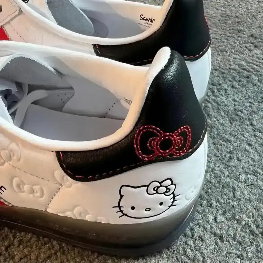 Women's Adidas Gazelle Indoor Hello Kitty White Red edition featuring custom bow laces, a premium white leather upper with bow texture, and iconic Sanrio branding on the tongue and heel.