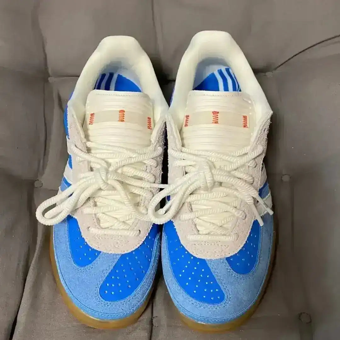 Pair of blue and white sneakers on a gray surface