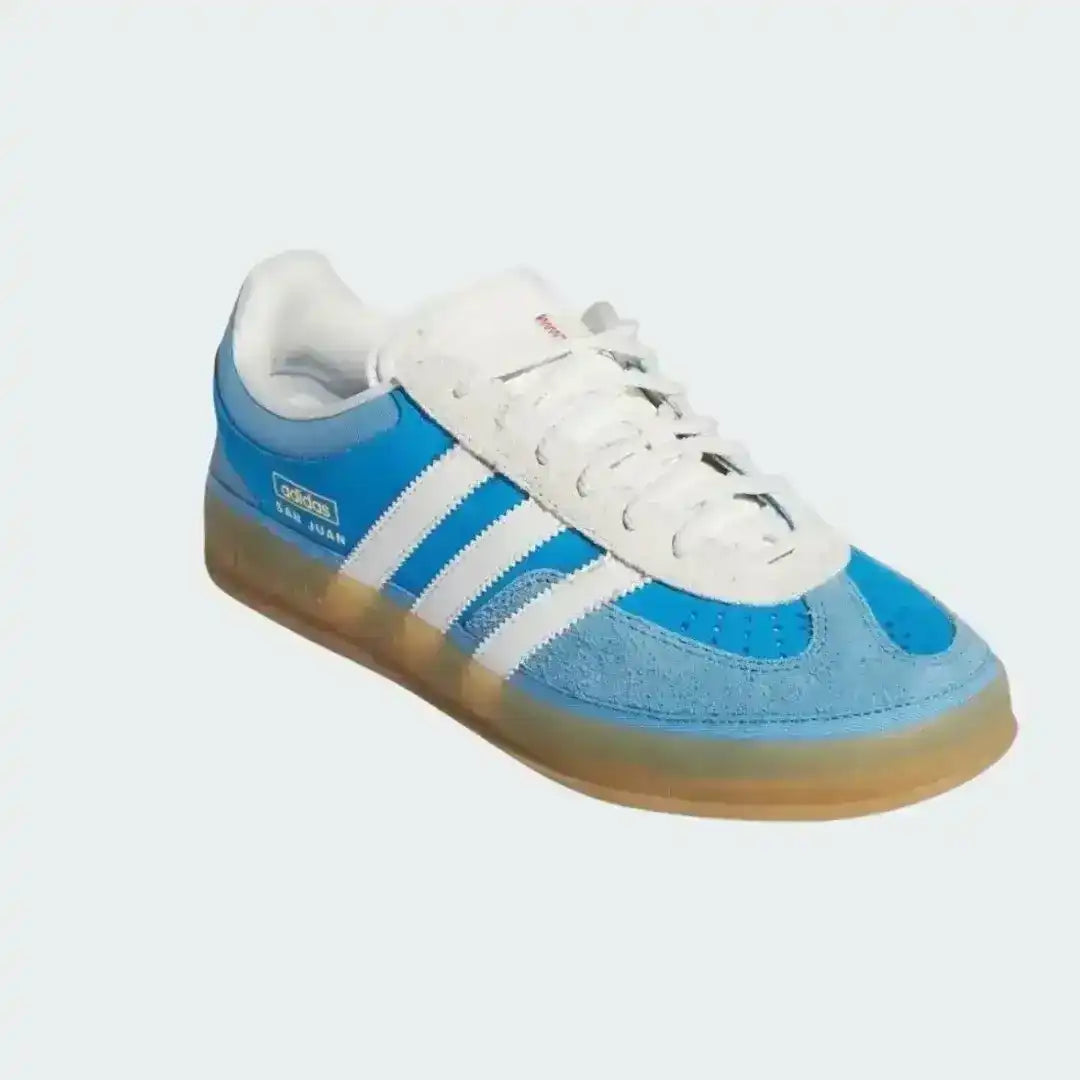 Blue and white sneaker with three stripes on a light gray background