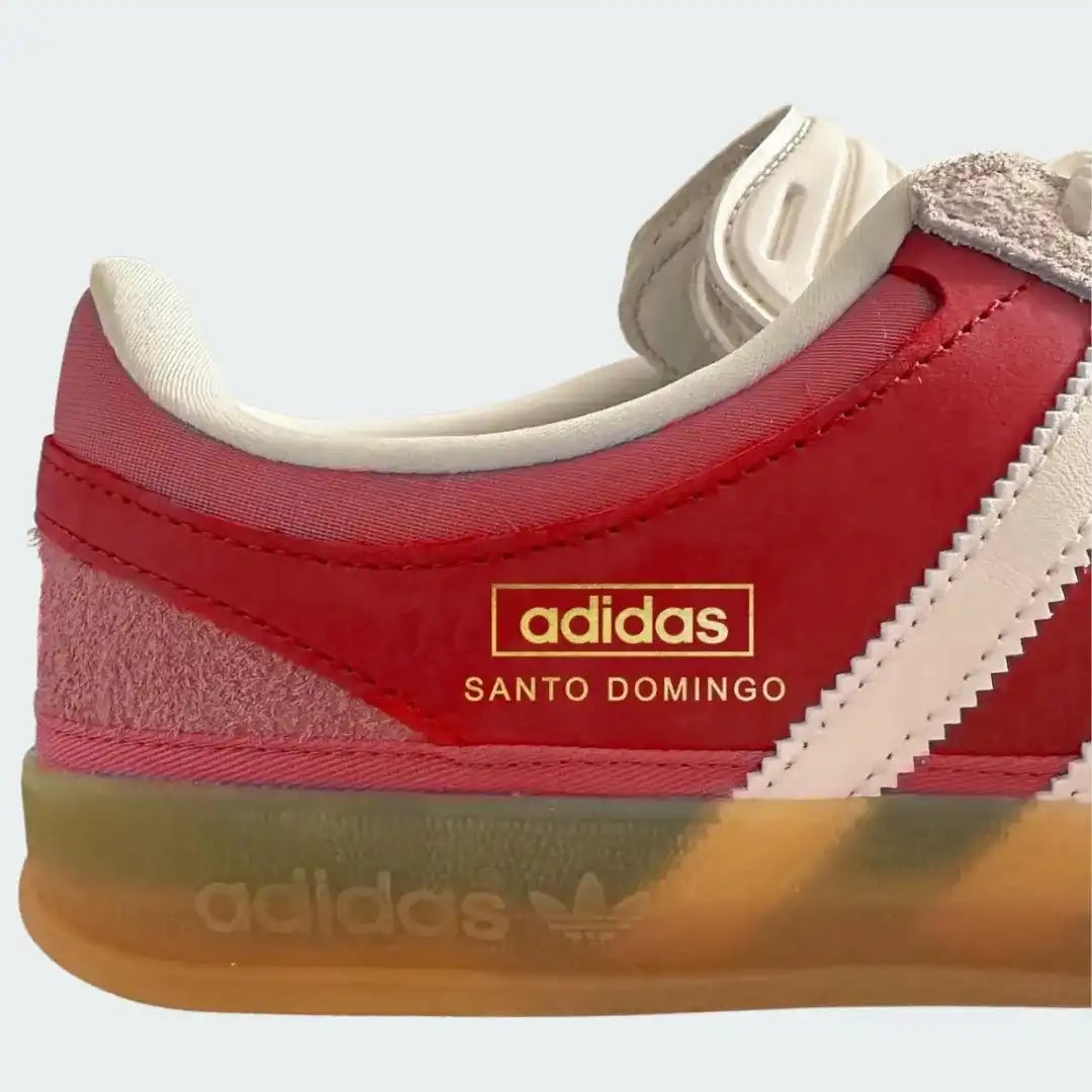 Red Adidas sneaker with 'Santo Domingo' text on a white background