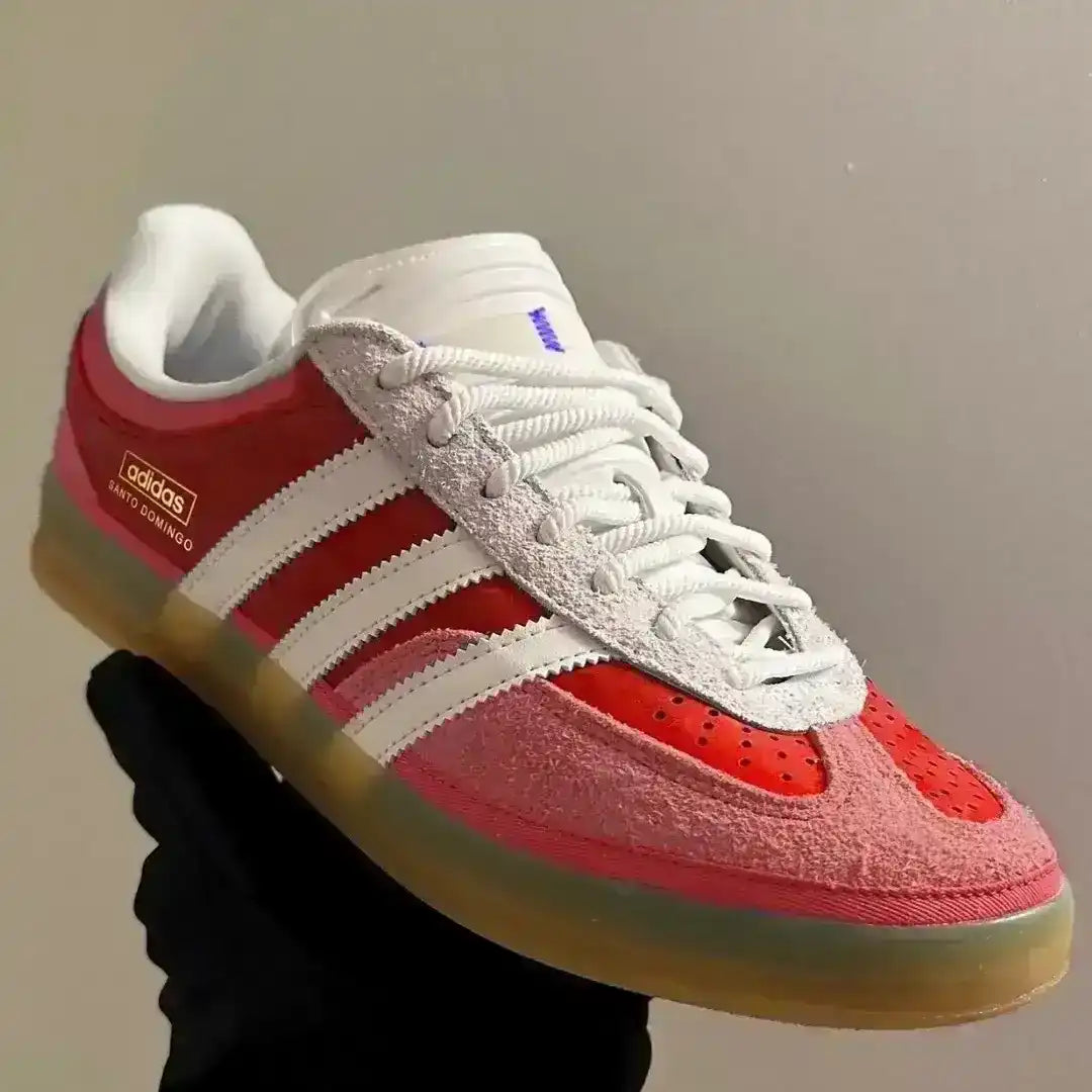 Red and white Adidas sneaker on a gray background