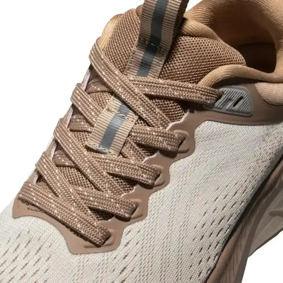 Stylish beige/khaki running shoes with mesh ventilation, soft foam cushioning, and a stable platform design for smooth, comfortable strides.