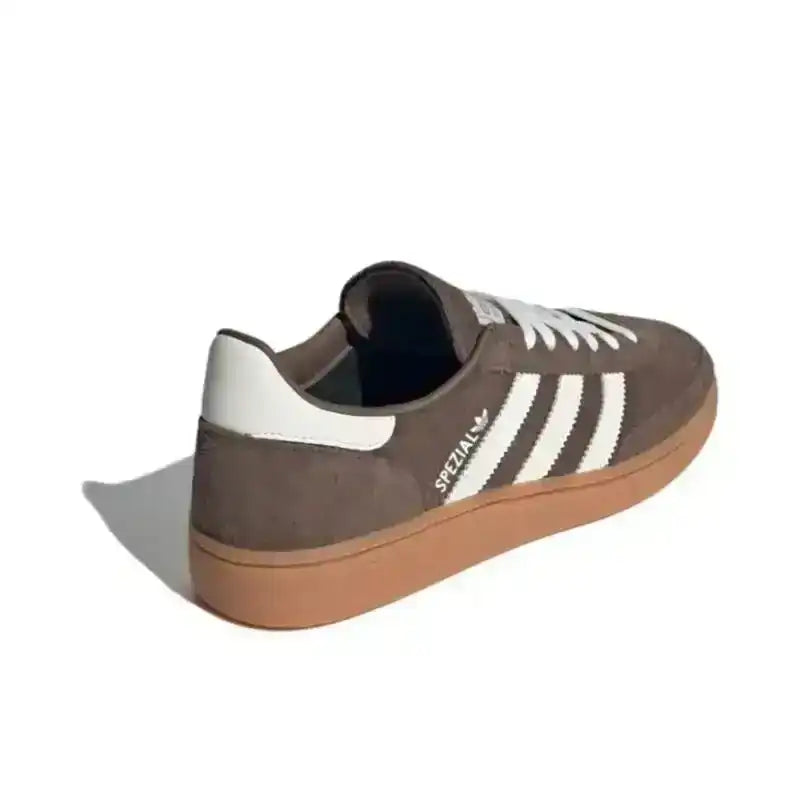 Brown three-stripe low-top sneakers with gum soles.