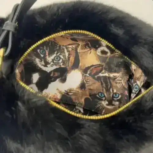 Close-up of the open top and patterned lining of a fuzzy cat-shaped handbag.