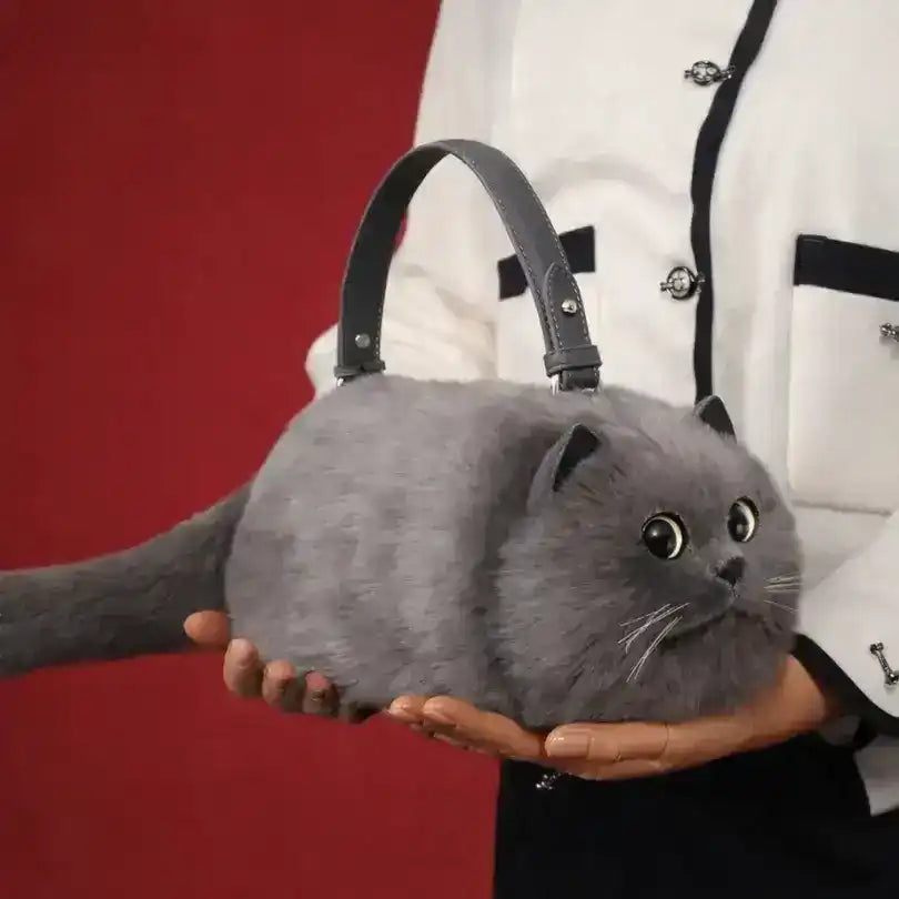 Fuzzy cat-shaped handbag with a handle and long tail detail.