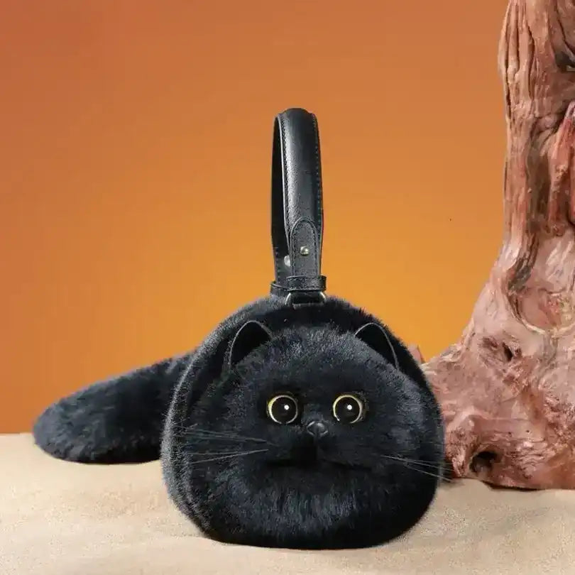 Fuzzy cat-shaped handbag with a handle and long tail detail.