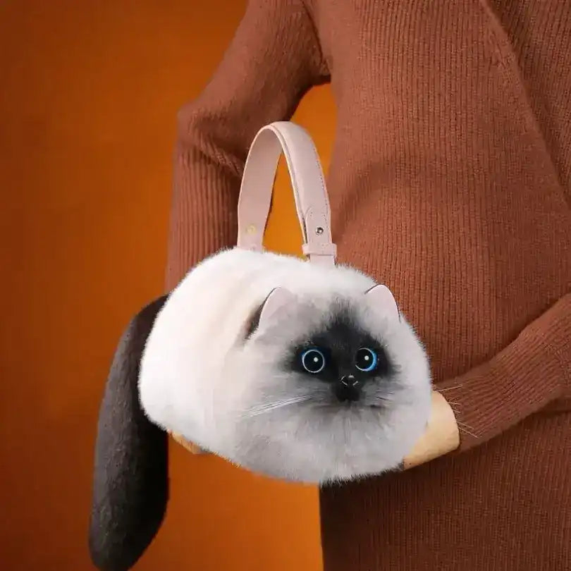 Fuzzy cat-shaped handbag with a handle and long tail detail.