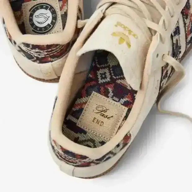 Cream low-top sneakers with multicolored patterned panels.