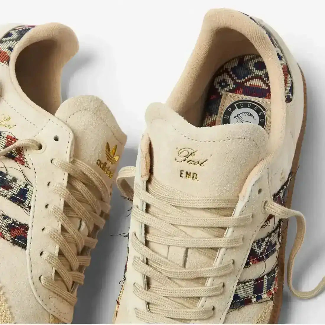 Cream low-top sneakers with multicolored patterned panels.