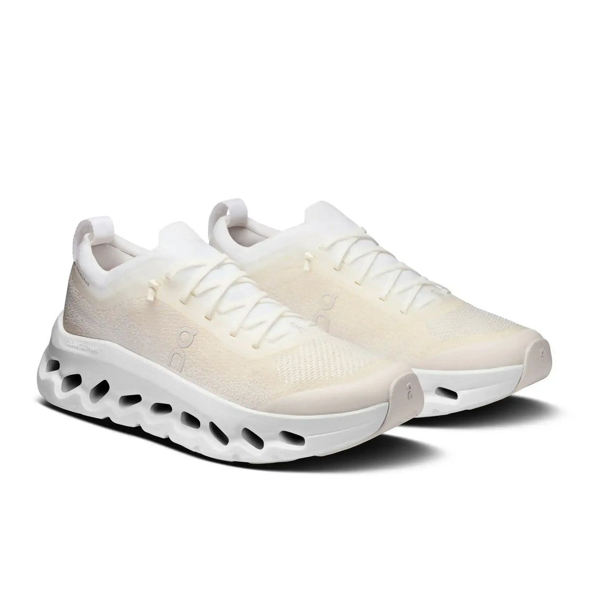 Off-white lace-up sneakers with cutout-style midsoles.