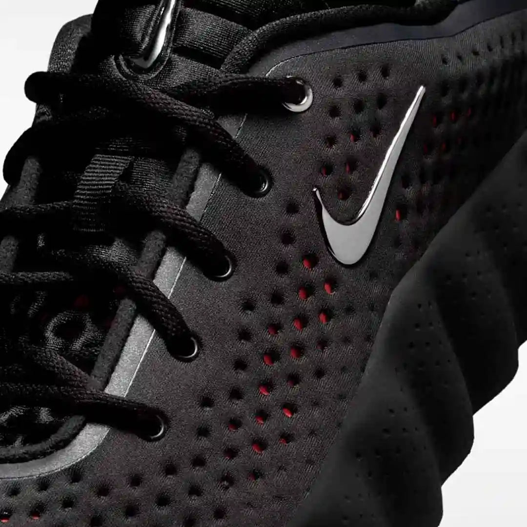 Close-up of black laces and perforated upper panels.