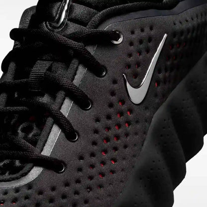 Close-up of black laces and perforated upper panels.