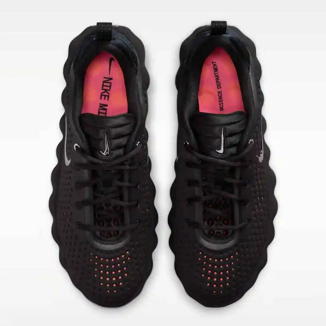 Black mesh-panel sneakers with red insoles, top view.