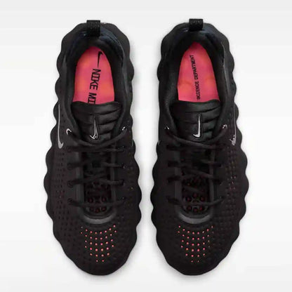 Black mesh-panel sneakers with red insoles, top view.