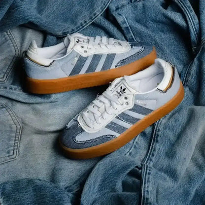 Blue denim-look low-top sneakers with pale laces and gum soles.