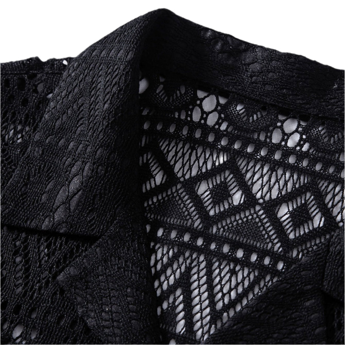 Close-up of the collar and patterned openwork on a black shirt.