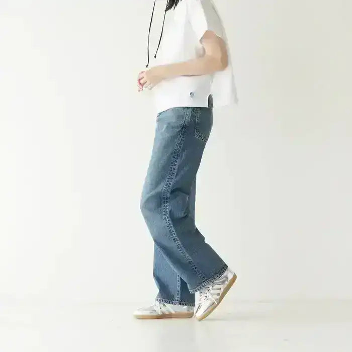 Silver-colored three-stripe low-top sneakers with gum soles.