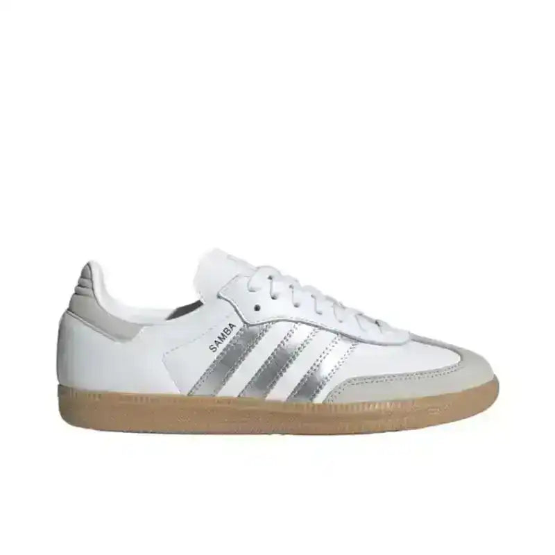 White low-top sneakers with silver-colored side stripes.