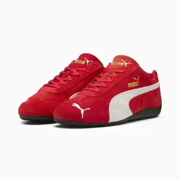 Red and white Puma sneakers on a white background