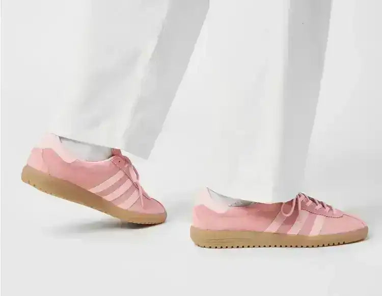 Pink low-top sneakers with gum soles, including on-foot styling.